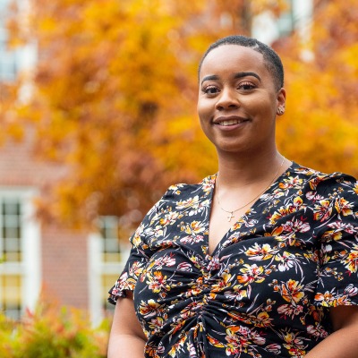 Alexandra Odom ’16 in front of a tree with autumn leaves