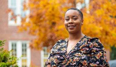 Alexandra Odom ’16 in front of a tree with autumn leaves
