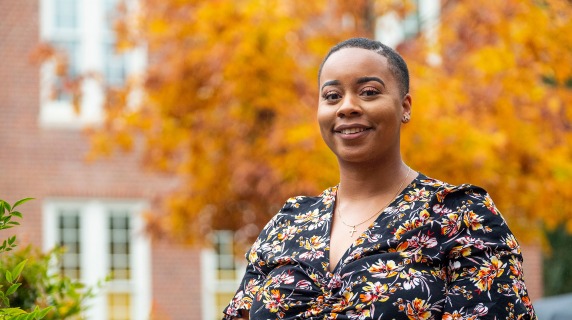 Alexandra Odom ’16 in front of a tree with autumn leaves