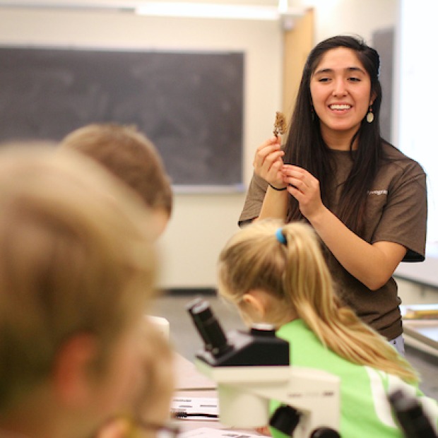 college student teaching elementary-age students