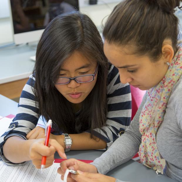 Grinnellians working together to solve a puzzle.