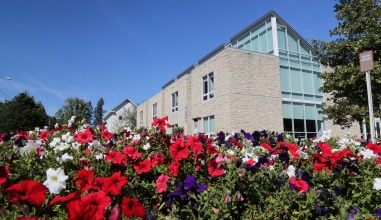 The John Chrystal Center with red flowers