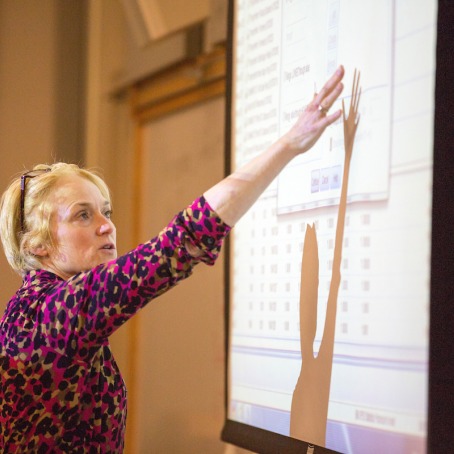 Barb Trish pointing at projection