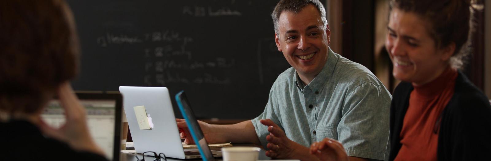 Faculty and students laughing