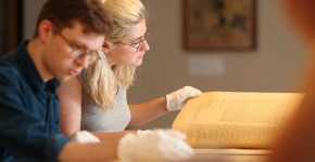 Students looking at documents in the archives