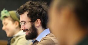Student smiling during discussion in classroom