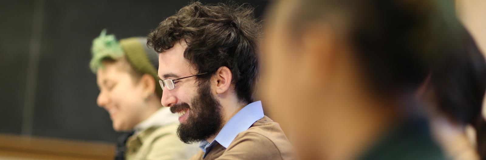 Student smiling during discussion in classroom
