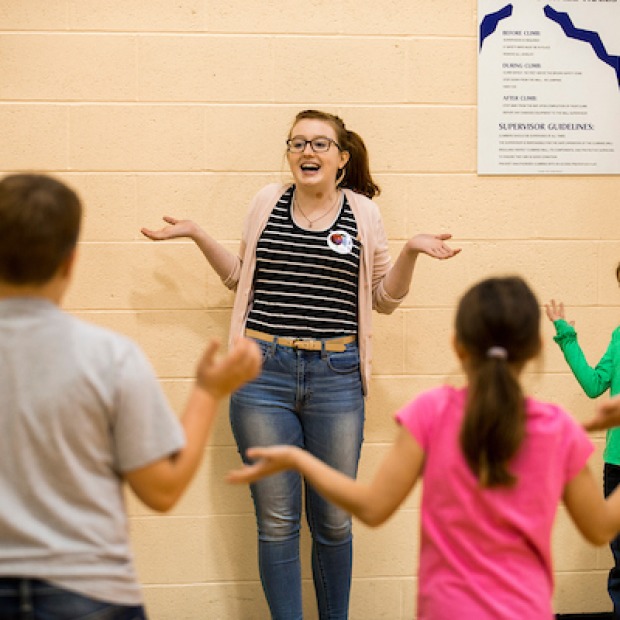 Lunchtime Language Learners college volunteer teaches a group of elementary students