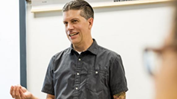 Ross Haenfler standing in front of a class