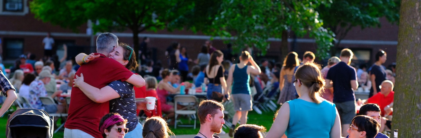alumni hug at reunion picnic