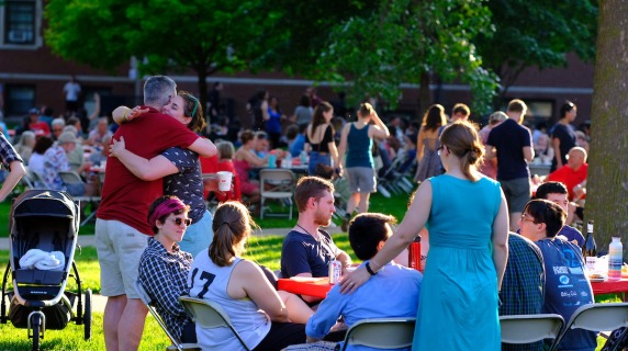 alumni hug at reunion picnic