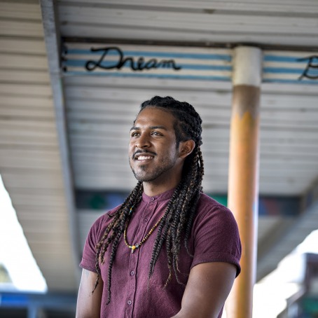 Erin Whalen ’12 under an awning that says "Dream Big"