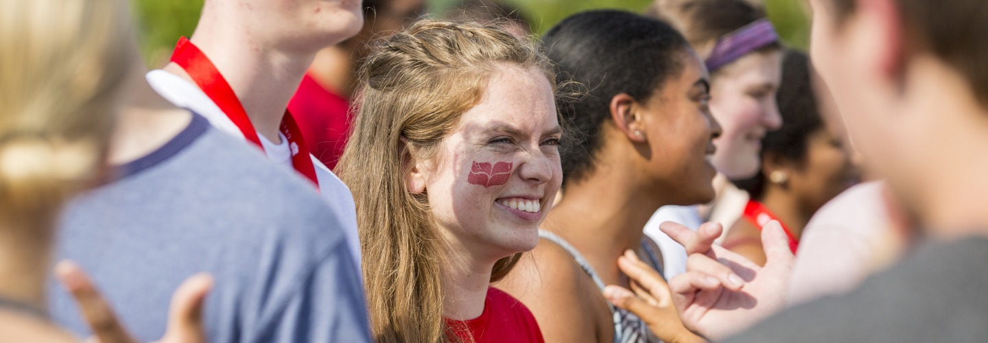 Student with college logo on cheek