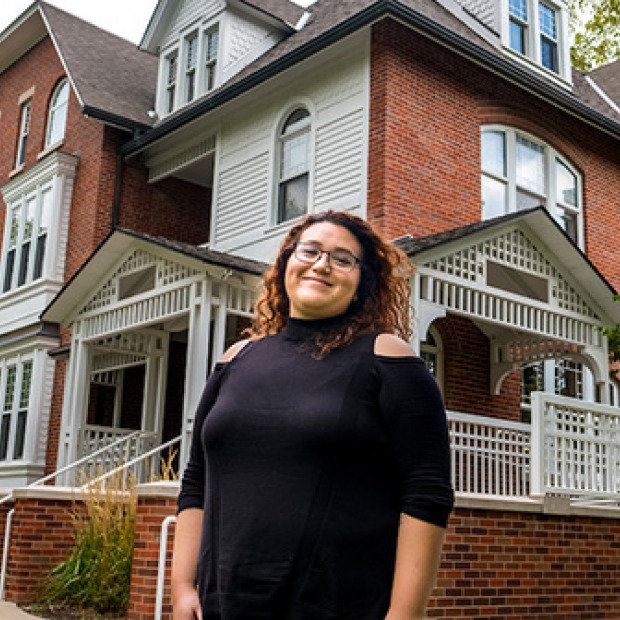 Lizeth Gutierrez ’12 in front of Mears Cottage