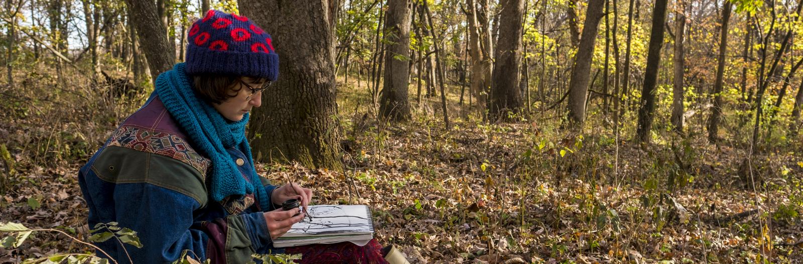Students in Lee Running, Associate Professor of Art, drawing class use observational drawing techniques during a trip to the Conard Evironmental Research Area