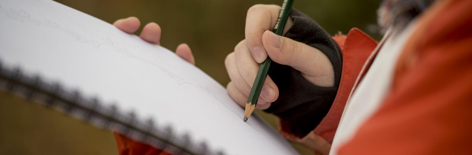 Student taking notes on paper