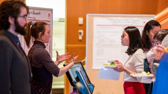 presenters and students discuss a digital project at the 2017 Teaching with Technology Fair at Grinnell College