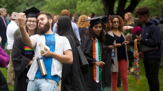 Graduate and guest take a selfie