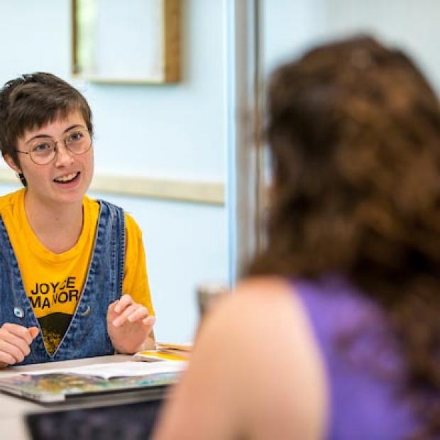 student and professor at table