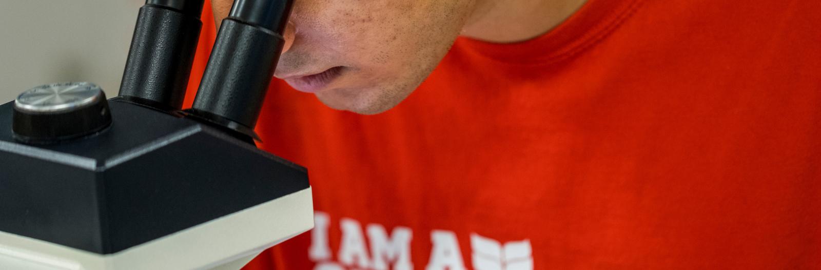 student at microscope