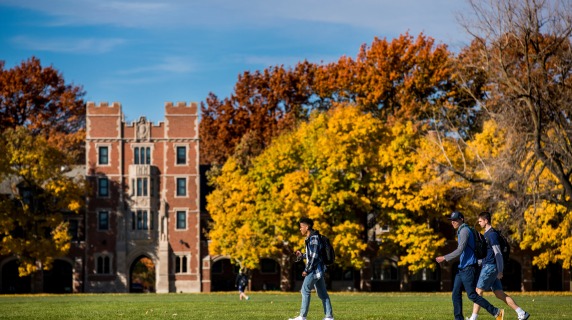 students walking on campus in the fall