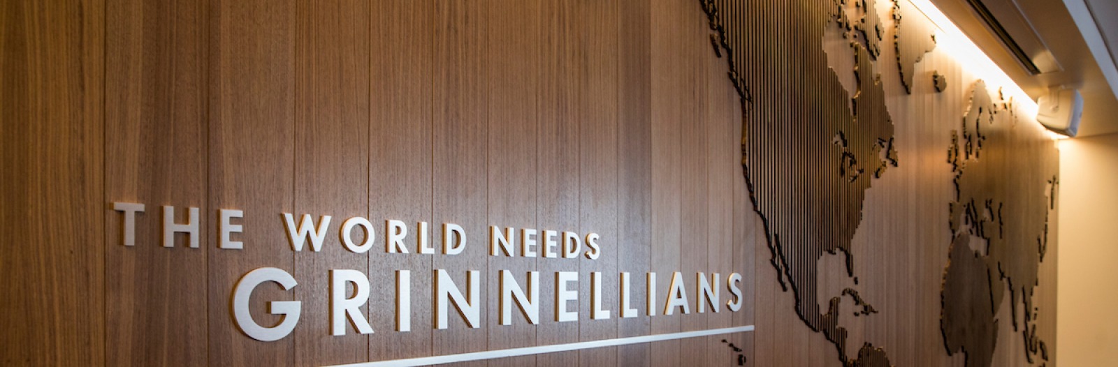 Wall in Admission and Student Financial Services room that says "The World Needs Grinnellians"