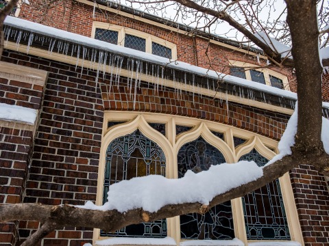 An outside view of Herrick Chapel with snow 