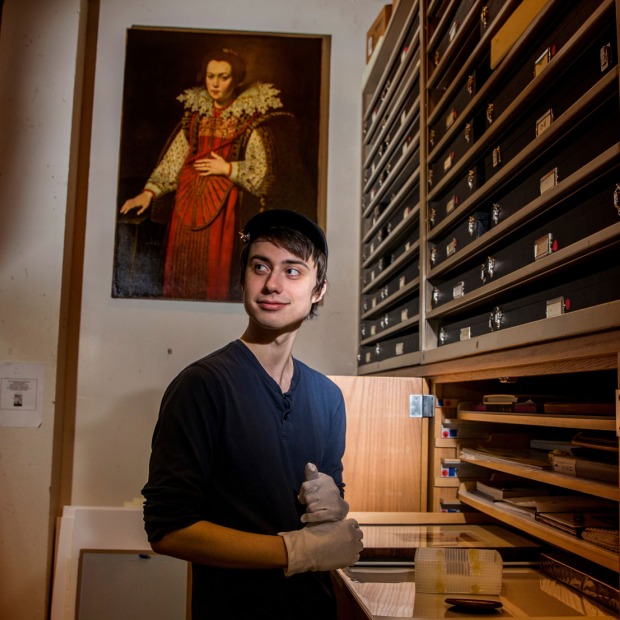 Owen Daley ’20 looking at different pieces in the Print and Drawing study room