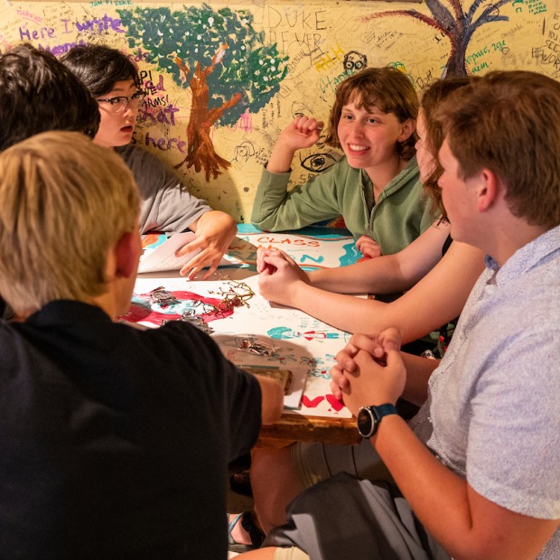 Students gather around a table at Bob's Underground Cafe