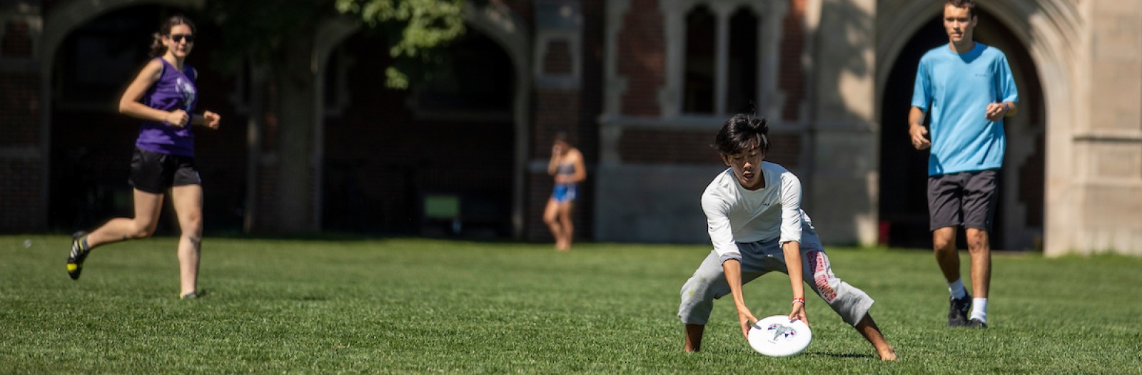 Students playing Ultimate on Mac Field, a large green space near college residence halls