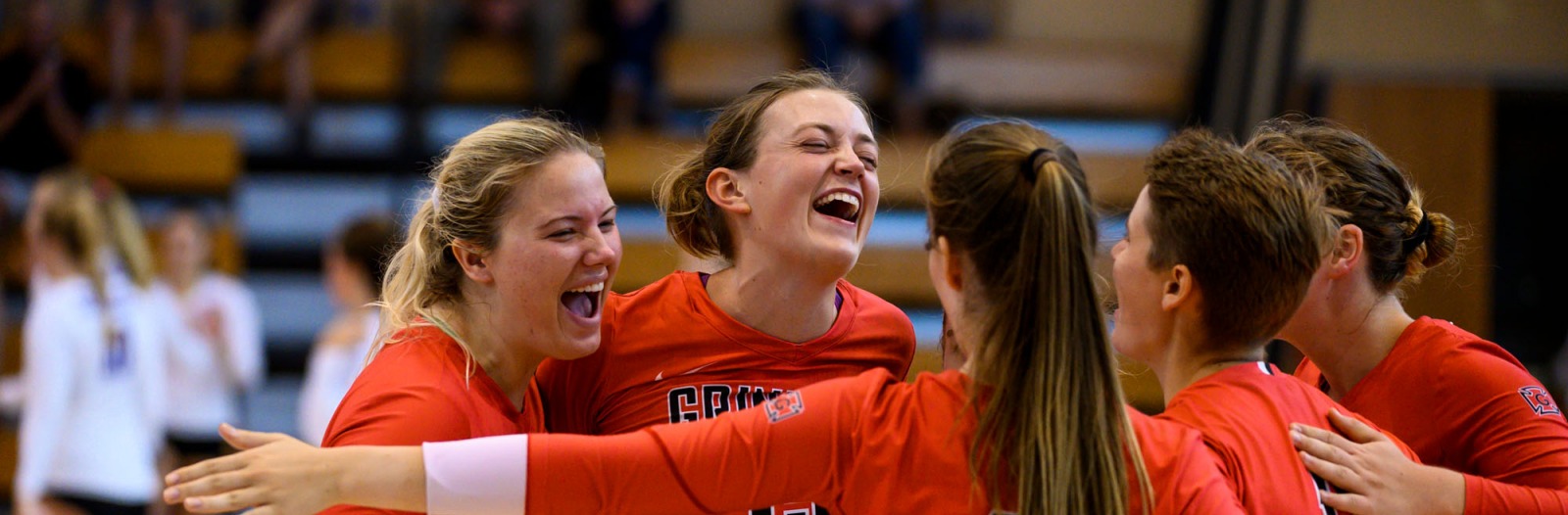women's volleyball team group hug