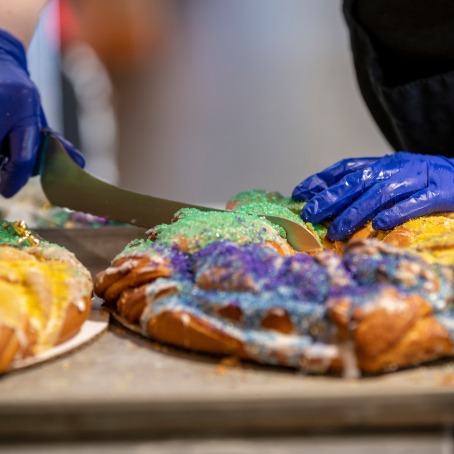 Mardi Gras king cake being sliced