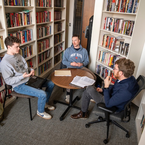 Two students with professor for history seminar
