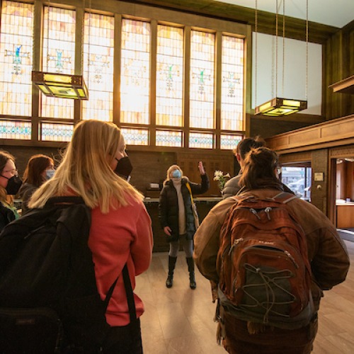 Art history students look at stained glass windows in Louis Sullivan's Merchants' Bank