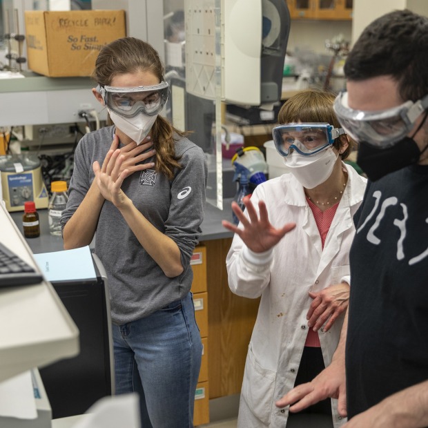 professor and 2 students in chemistry lab