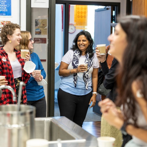 students and Jai standing in global kitchen