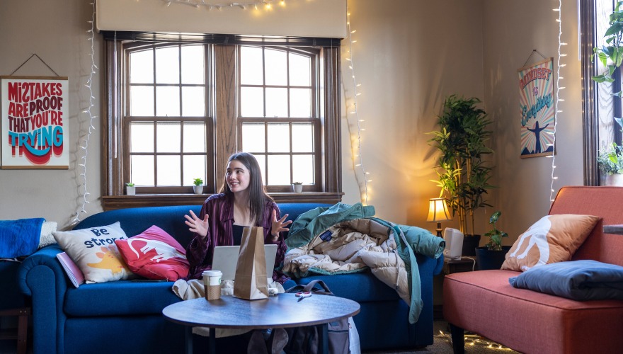 person studying on couch with a coffee 