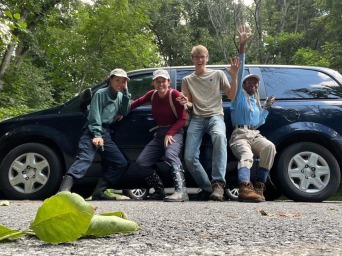 Mia and her friends all pose in front of a car at the Delaware State Parks