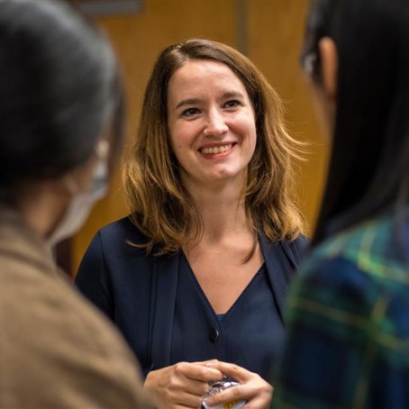 woman talking with students