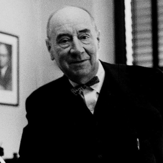 An older Joseph Welch stands at a desk 