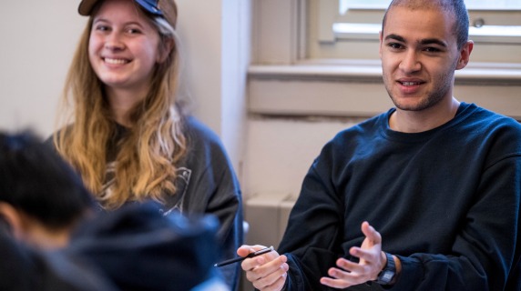 Students in a classroom smiling.