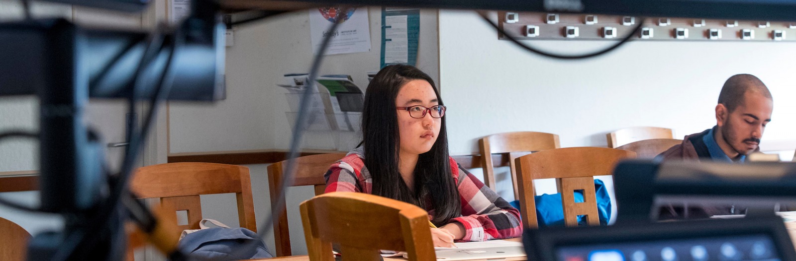 2 students with computer monitors in foreground