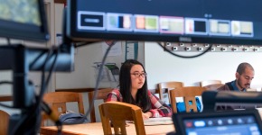 2 students with computer monitors in foreground