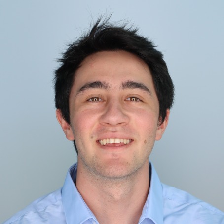 A man smiles for a headshot