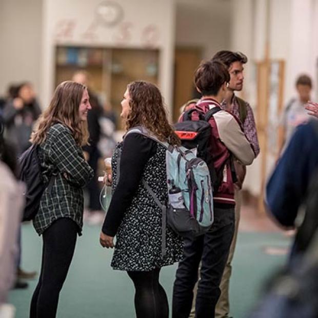 students greet each other in the hallway of ARH