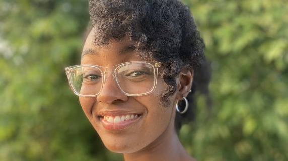 Ashley Jackson surrounded by greenery.