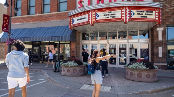students downtown in front of Strand theater