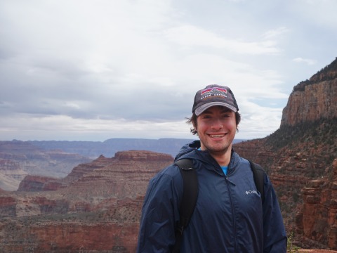 Ben Brim smiles with the Grand Canyon behind him