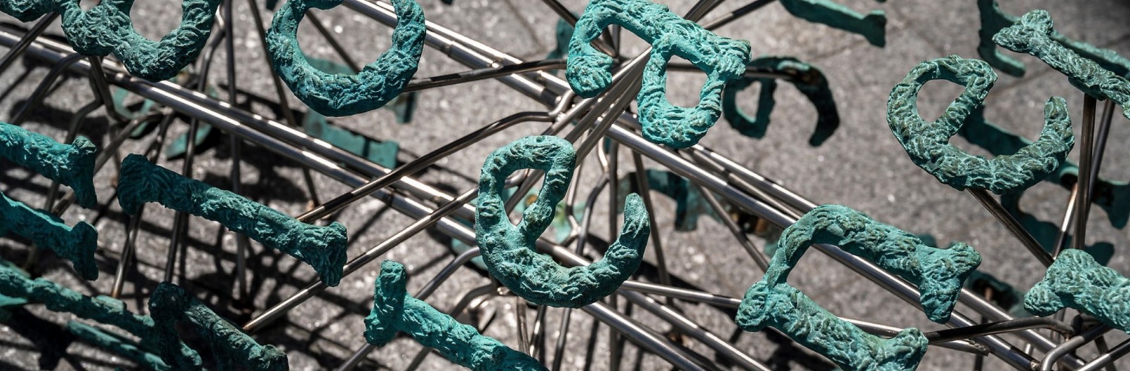 Broken English by Gregory Gómez - Sand-cast bronze letters with patina repeat the first few lines of The Second Coming by Yeats