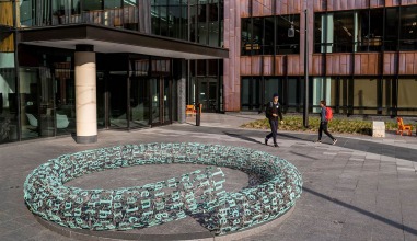 Students walk by "Broken English" installation in HSSC courtyard